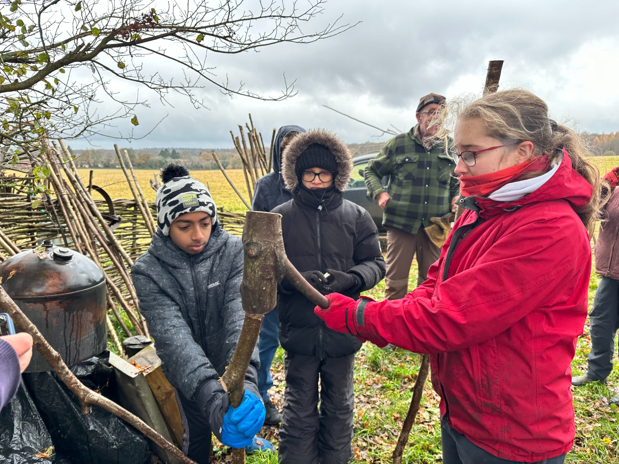 Students use a 'bosher' to create a fence