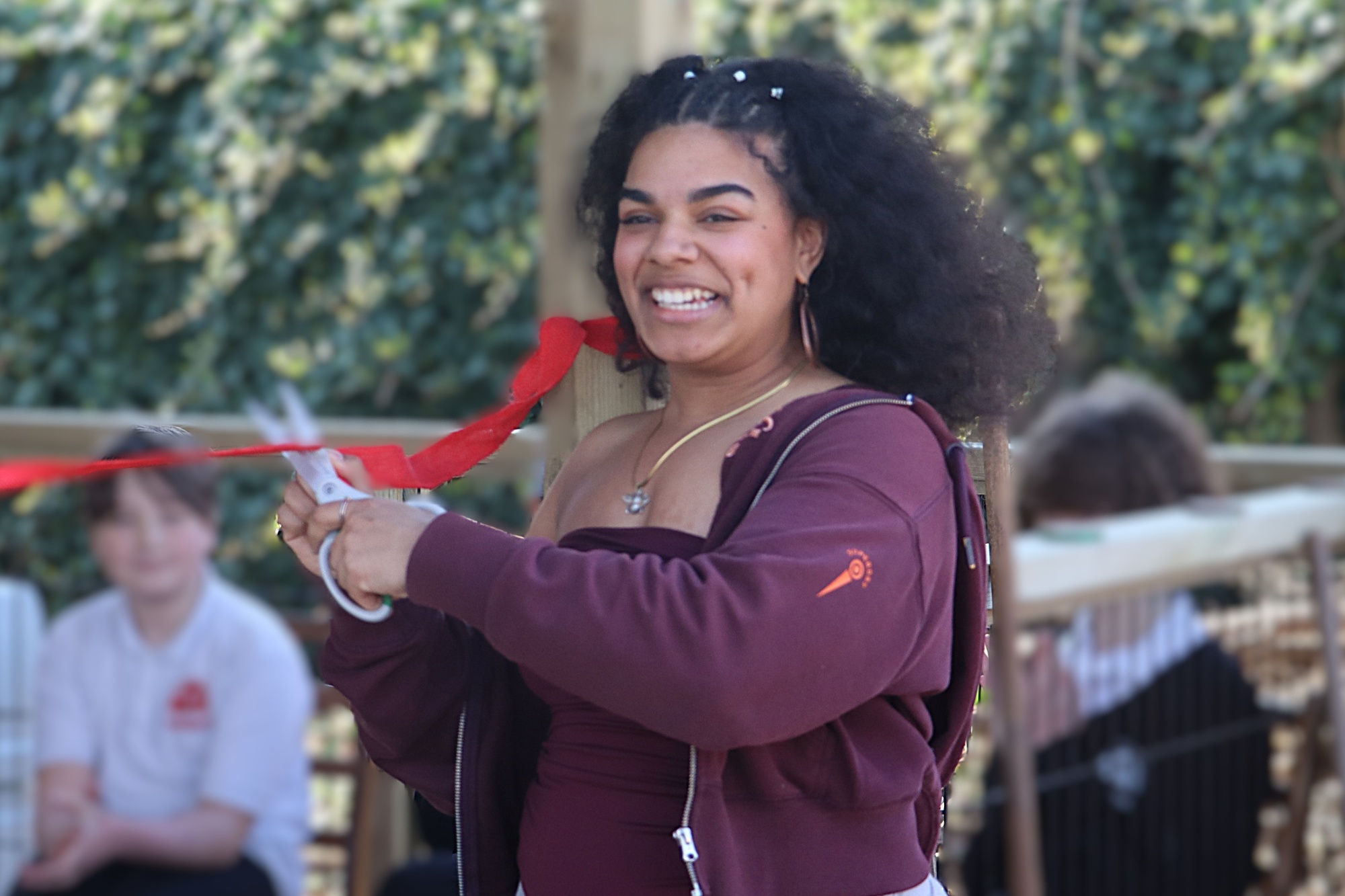 Beth cuts the ribbon to the Bee Room