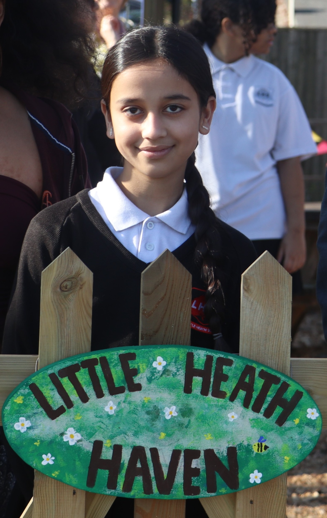 Rasmeen with the sign for the 'Little Heath Haven'