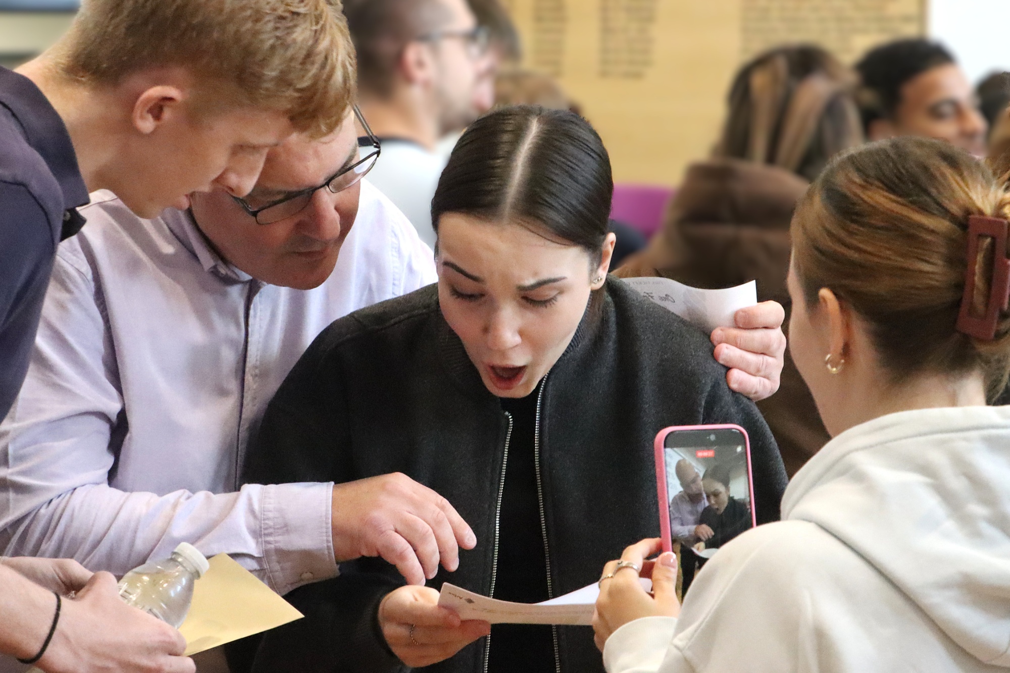 Supportive family celebrate exam success