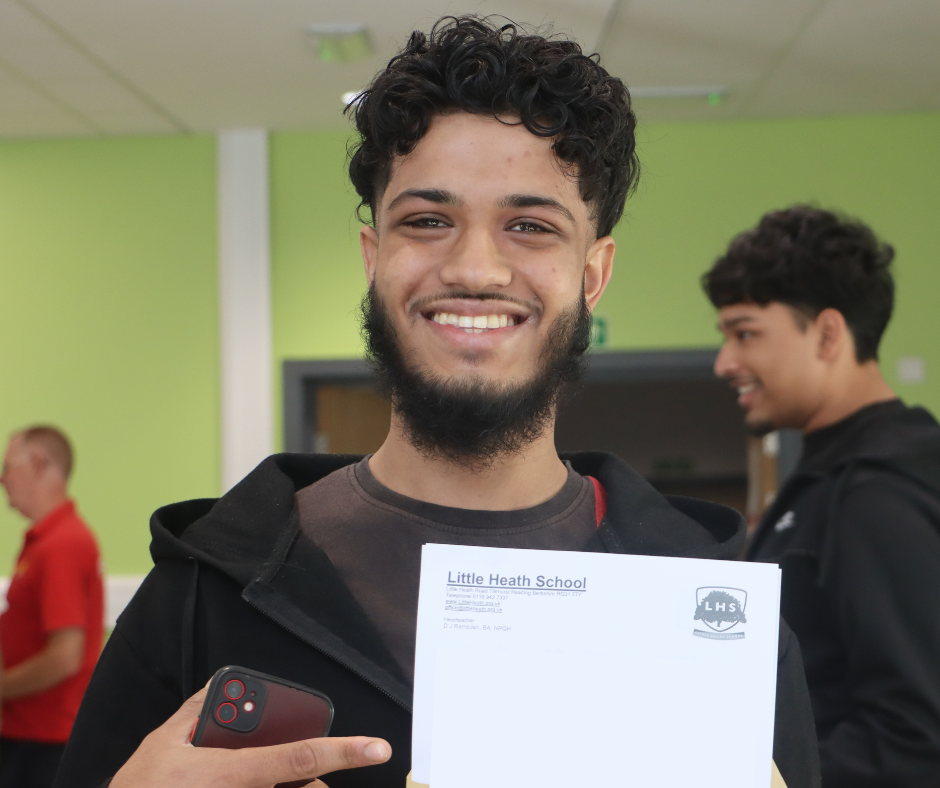Student posing with their A Level Results