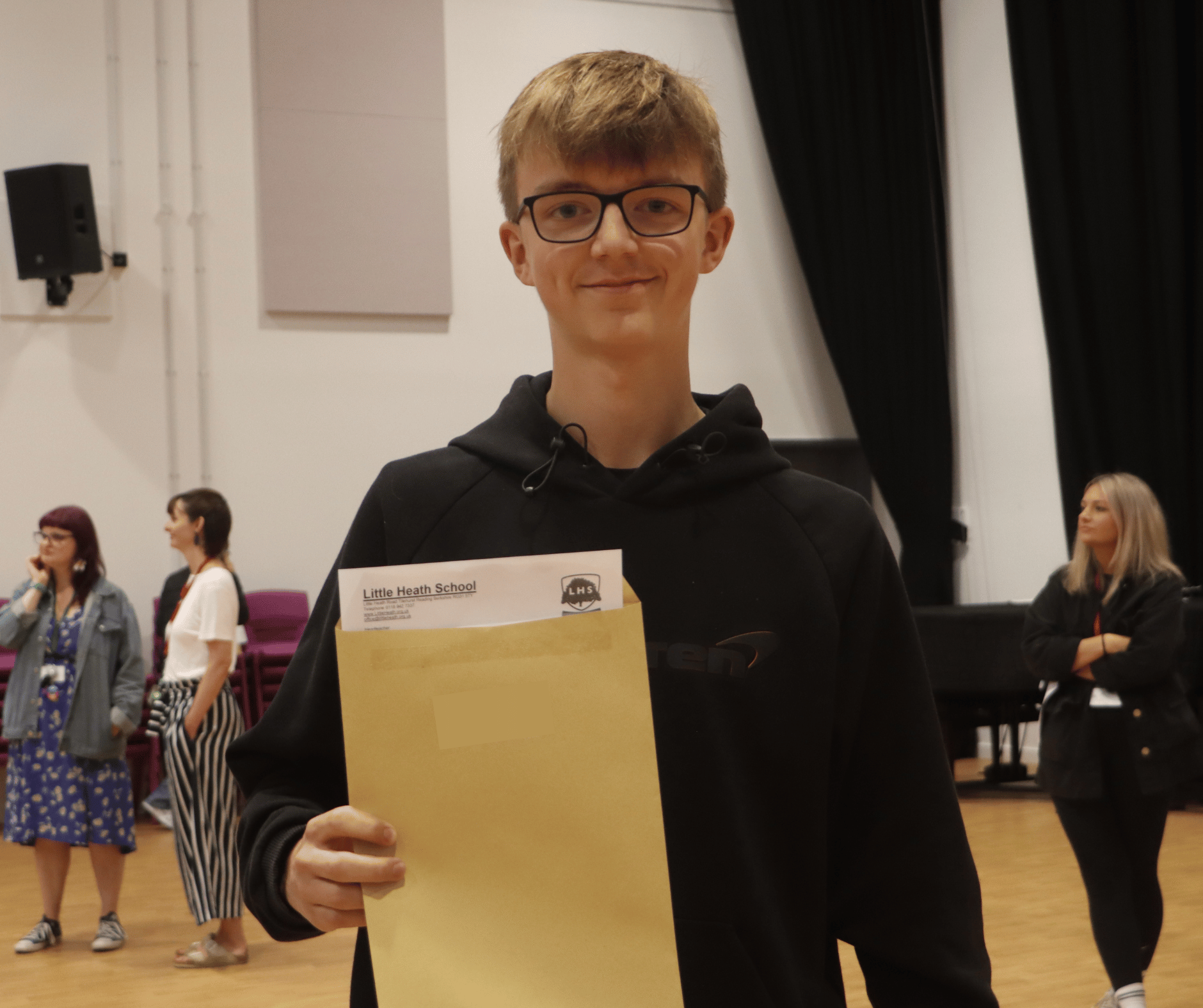 Students posing with their results envelopes