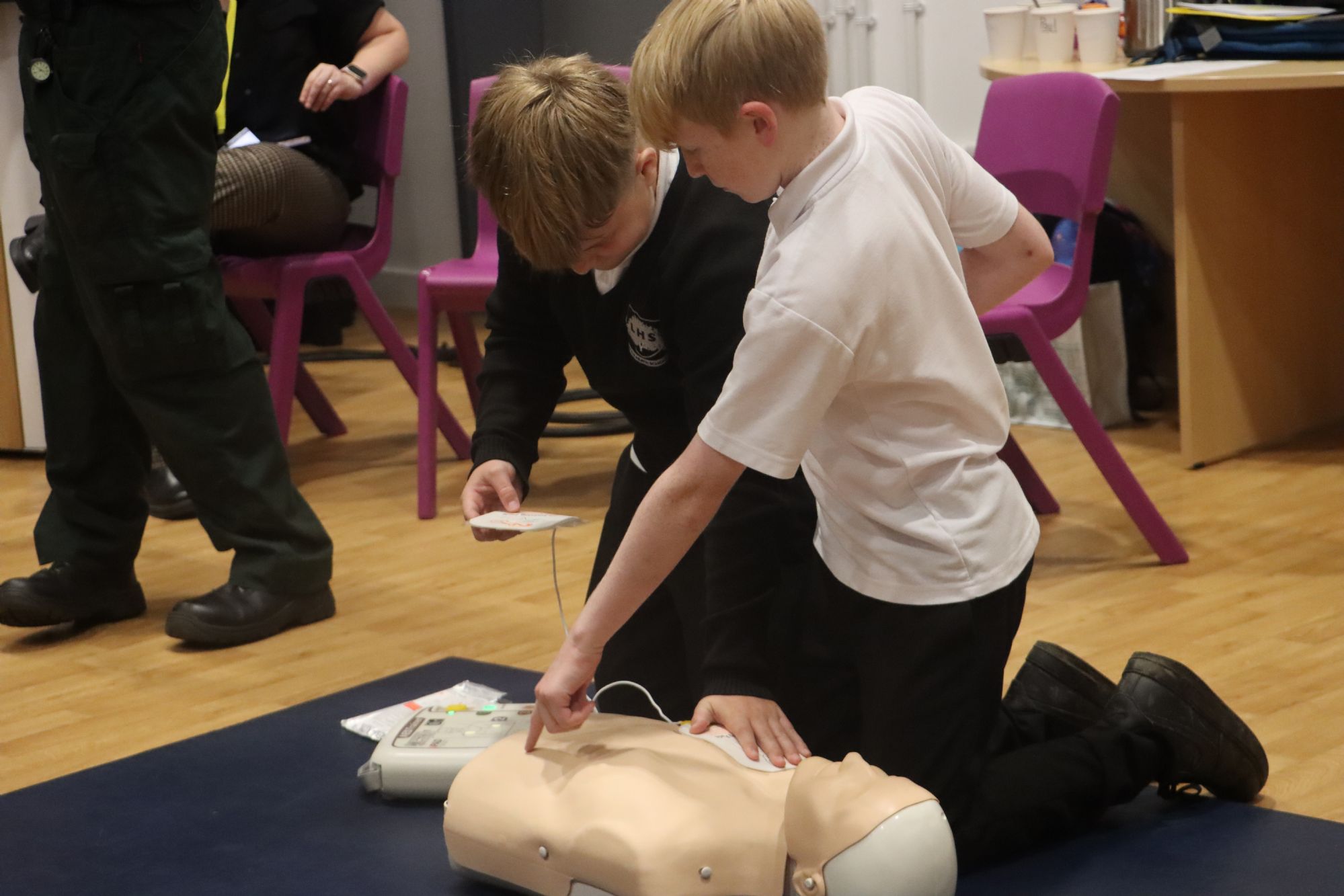 Students practice with a defibrillator